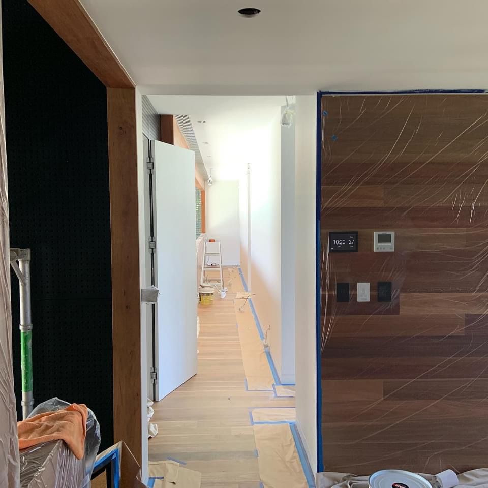 A hallway with a wooden wall and a white door