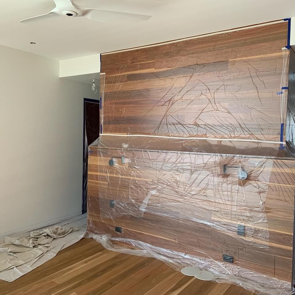 A room with a wooden wall and a ceiling fan.