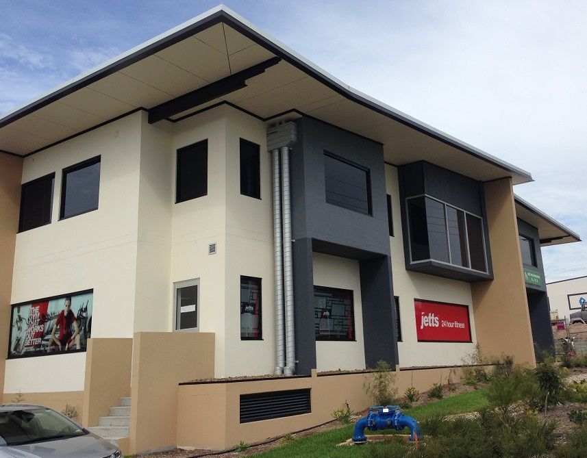 A large building with a red sign that says ms on it