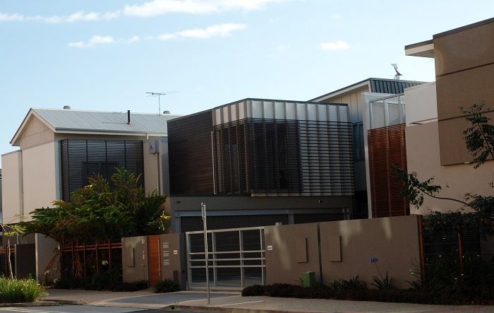 A row of houses with a fence around them