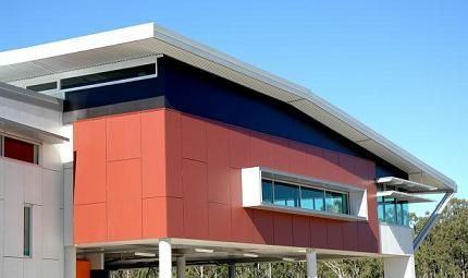 A large red and white building with a blue sky in the background.