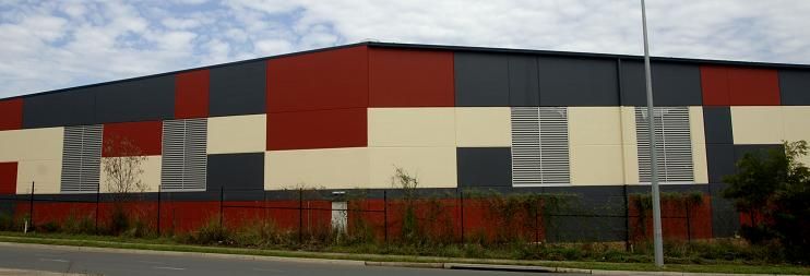 A red , white and black building with a checkered pattern on the side.