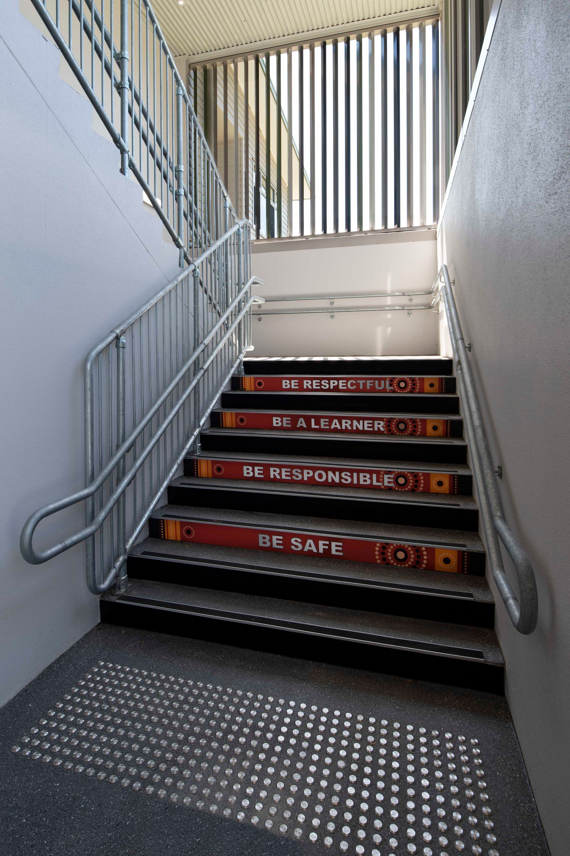A set of stairs with a railing and a sign on the steps that says fc kingston