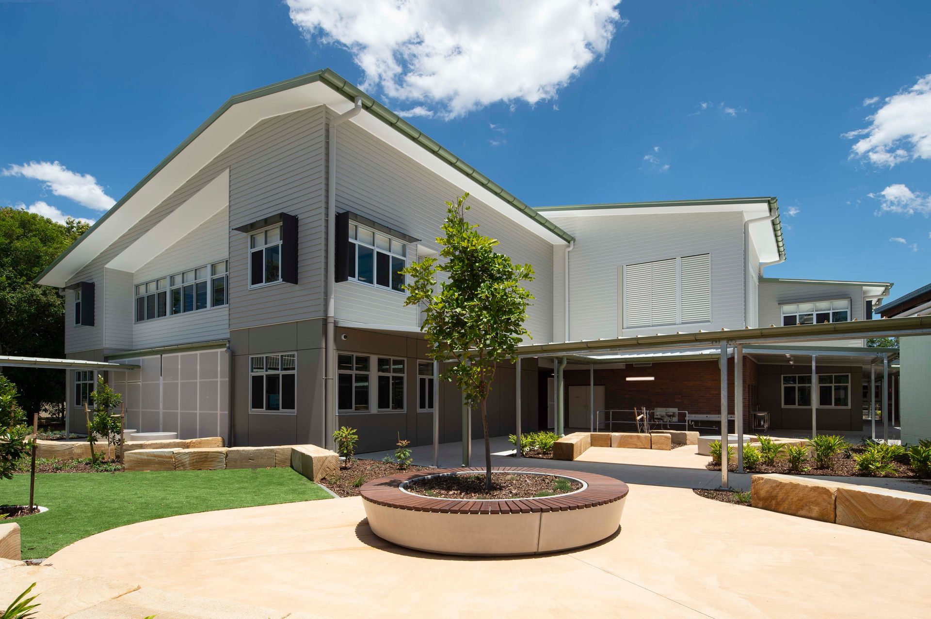 A large white building with a tree in front of it