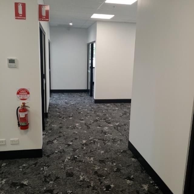 A hallway with a fire extinguisher on the wall.