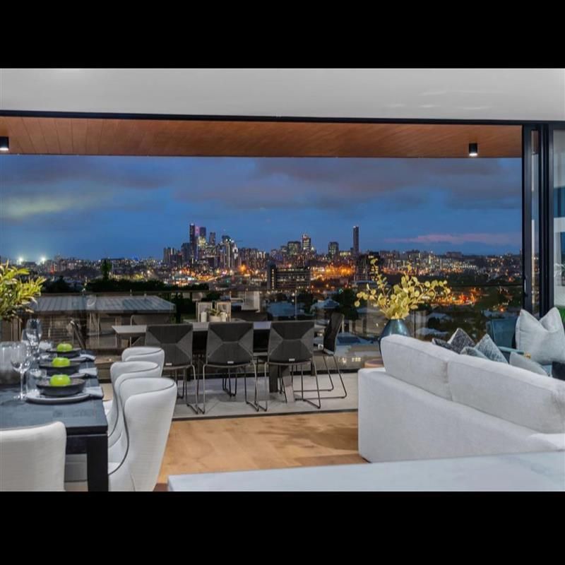A living room with a view of a city at night