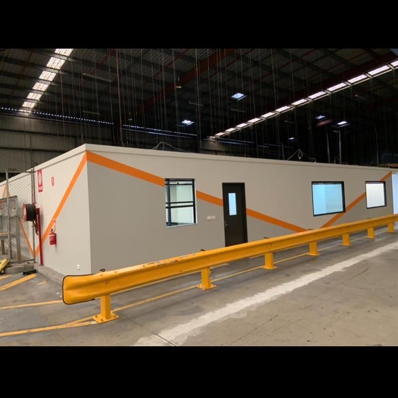 A large building with a yellow railing in front of it