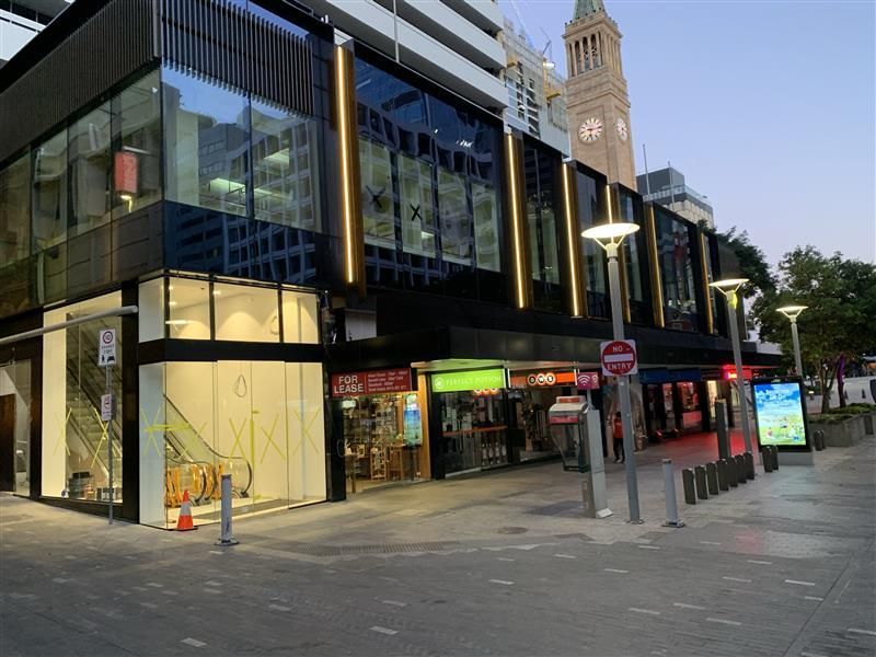 A large building with a clock tower in the background.