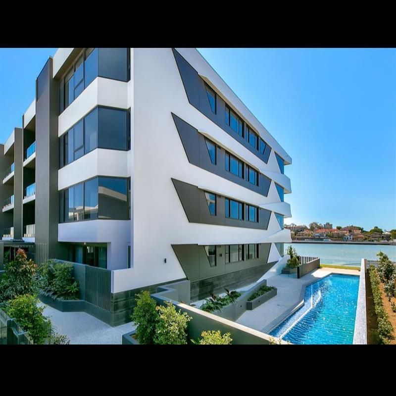 A large building with a swimming pool in front of it