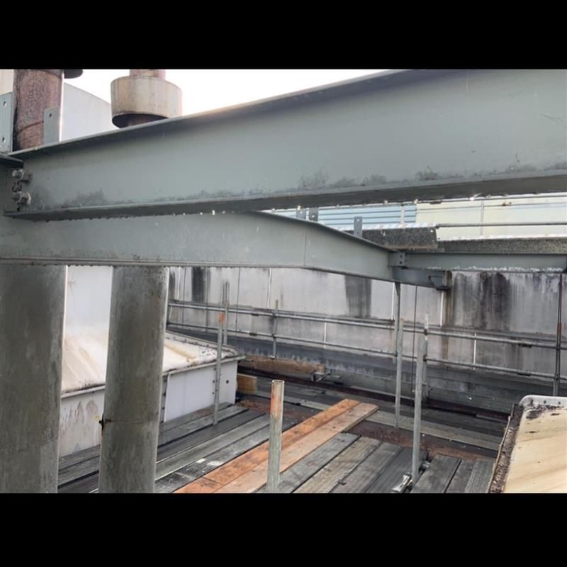 A metal structure is being built on top of a wooden deck.