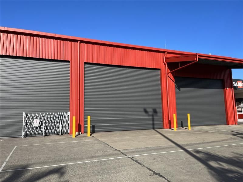 A red building with a lot of garage doors