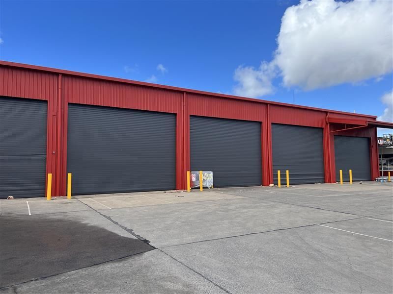 A red building with a lot of garage doors
