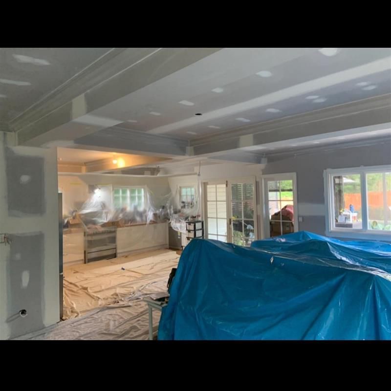 A large room with a blue tarp on the floor.