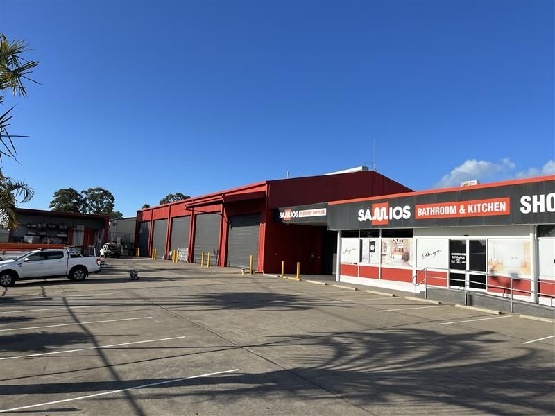 A white truck is parked in front of a building.