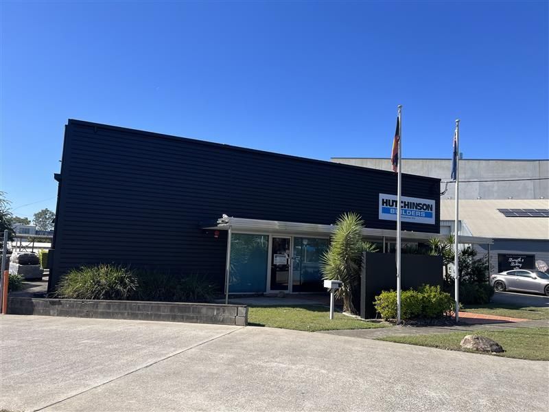 A large black building with flags in front of it.
