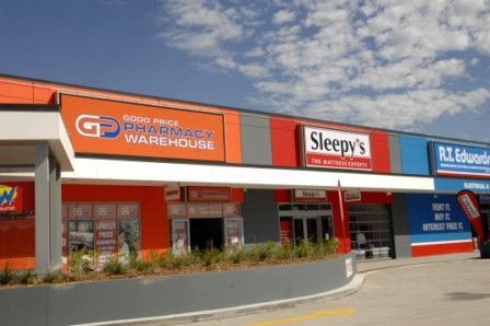 A pharmacy warehouse with a sleepy 's store in the middle of it.