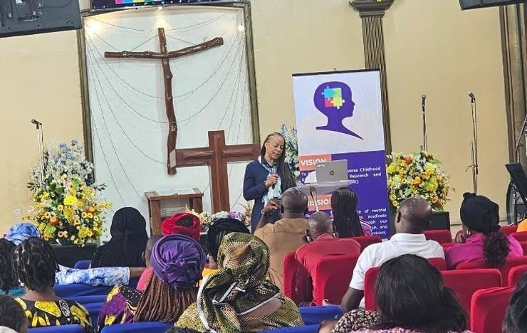 A man is giving a speech in front of a crowd of people in a church.