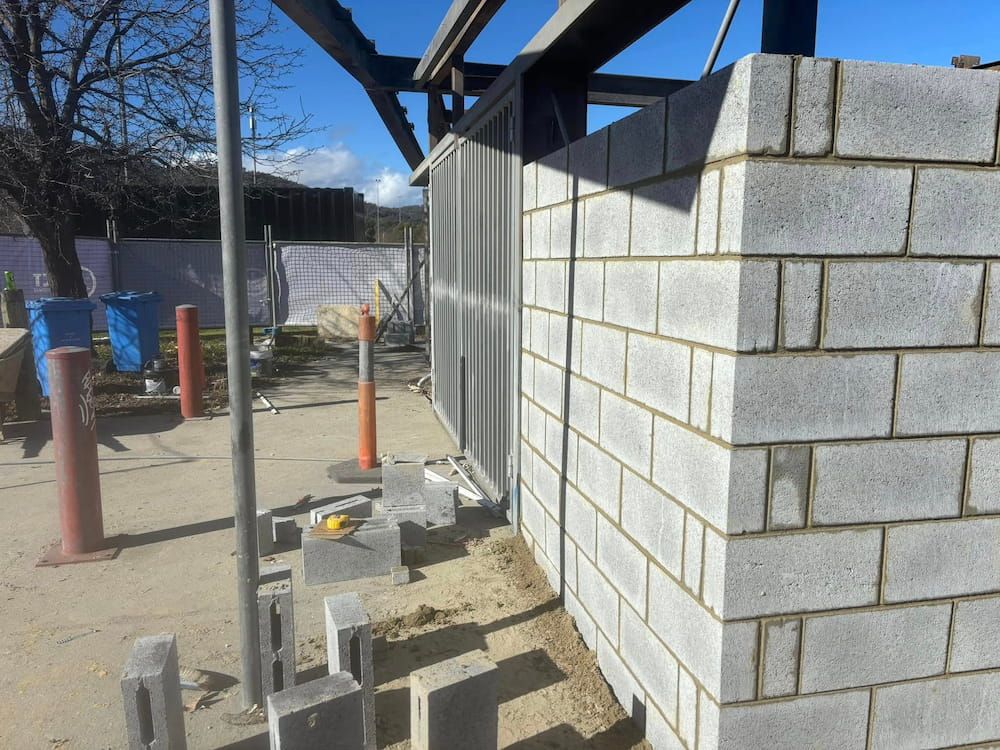 A Brick Wall is Being Built on a Construction Site — Ozi Construction Pty Ltd in Bondi, NSW