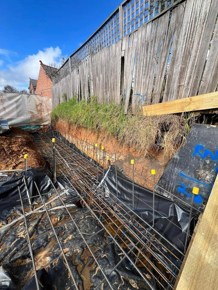 A Construction Site With a Wooden Fence in the Background — Ozi Construction Pty Ltd in Wollongong, NSW