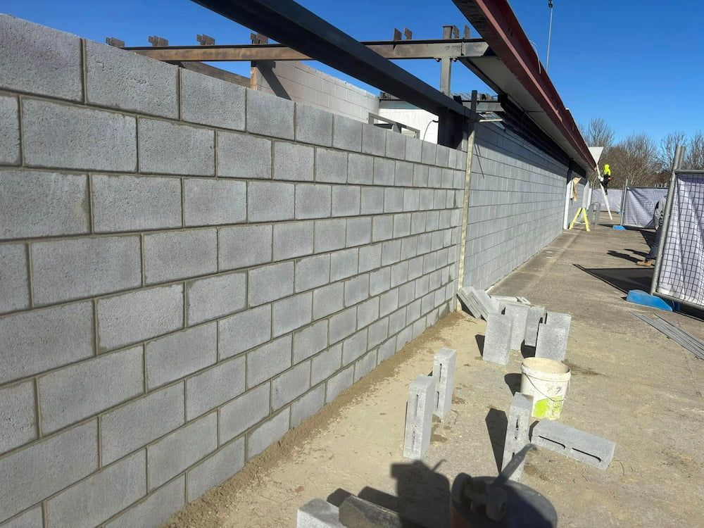 A Brick Wall is Being Built on a Construction Site — Ozi Construction Pty Ltd in Bondi, NSW