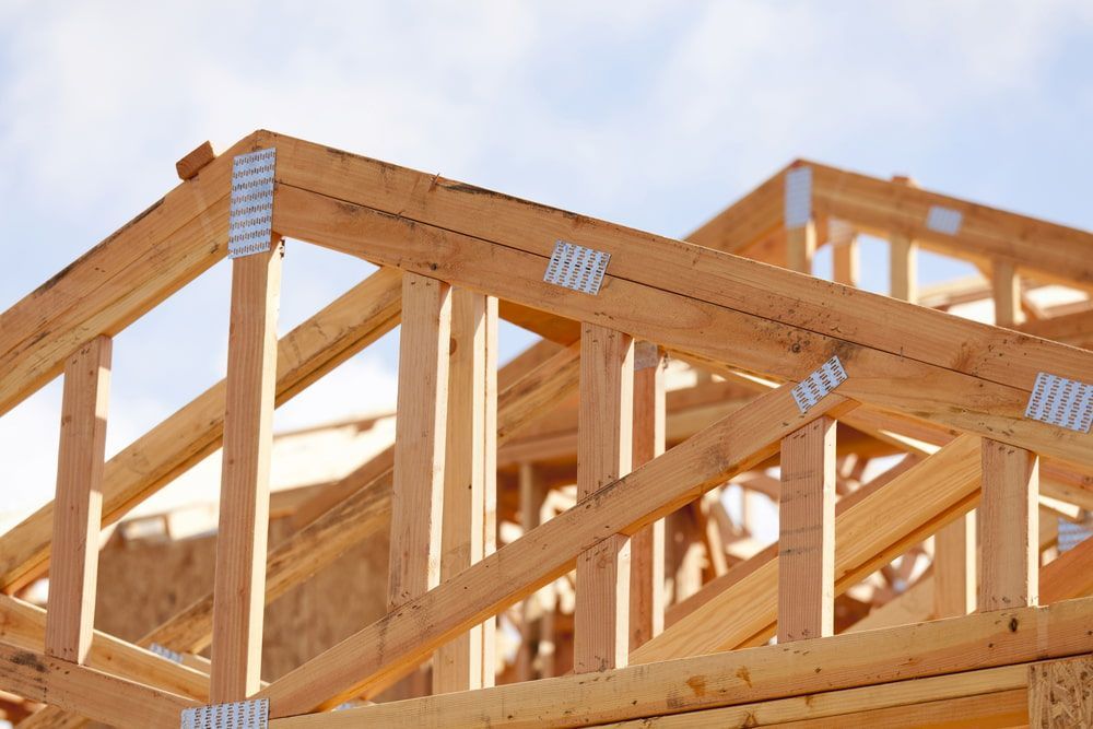 A Wooden Structure is Being Built With a Blue Sky in the Background — Ozi Construction Pty Ltd in Wollongong, NSW