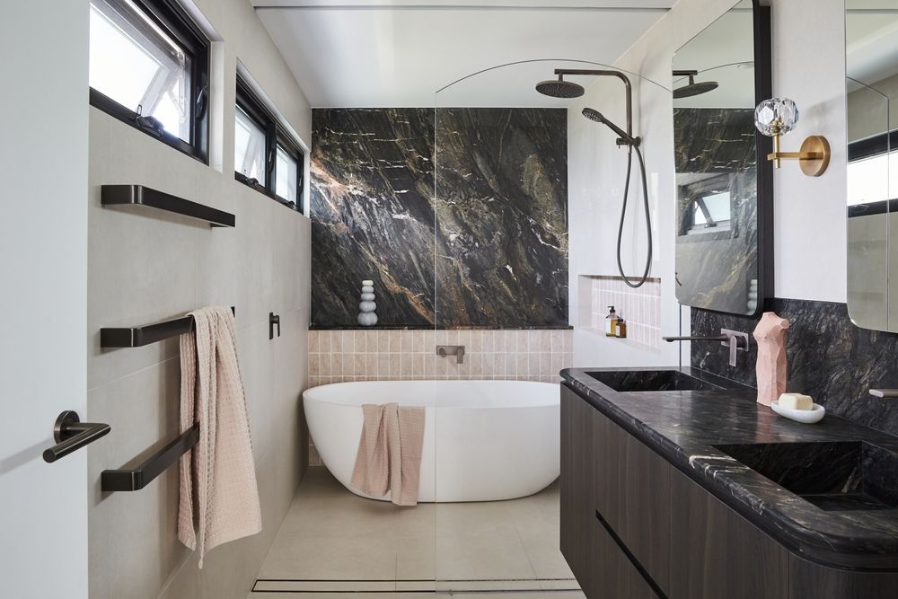 Modern Bathroom With Black Marble Accents, a Freestanding Tub, and Dark Wood Vanity — Ozi Construction Pty Ltd in Griffith, ACT