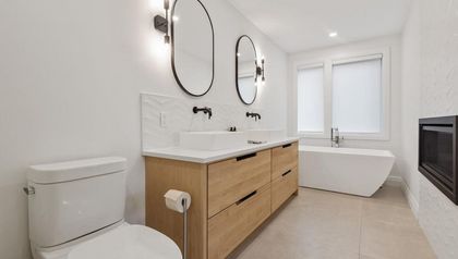 A Bathroom With Two Sinks, a Toilet, and a Bathtub — Ozi Construction Pty Ltd In Griffith, ACT