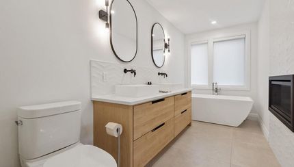 A Bathroom With Two Sinks, a Toilet, and a Bathtub — Ozi Construction Pty Ltd In Griffith, ACT