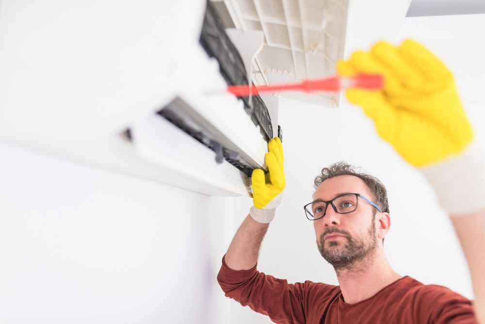 Fixing AC unit and cleaning the filters — Air Conditioning Repairs in Nowra NSW