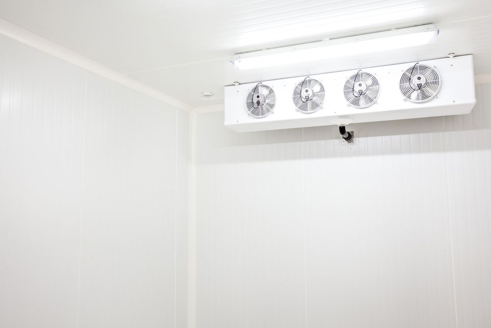 An Empty Industrial Room Refrigerator with Four Fans — Air Conditioning Repairs in Ulladulla NSW