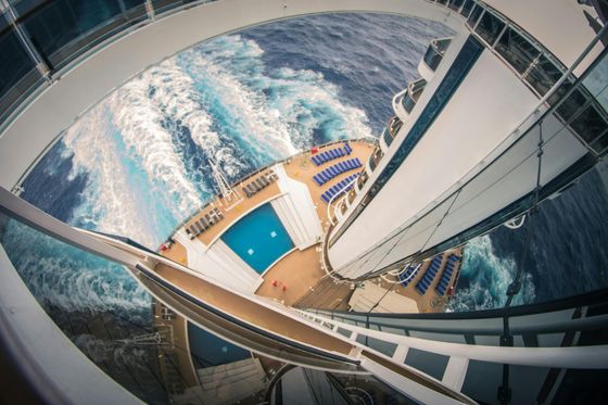 A cruise ship is going down a spiral staircase in the ocean.