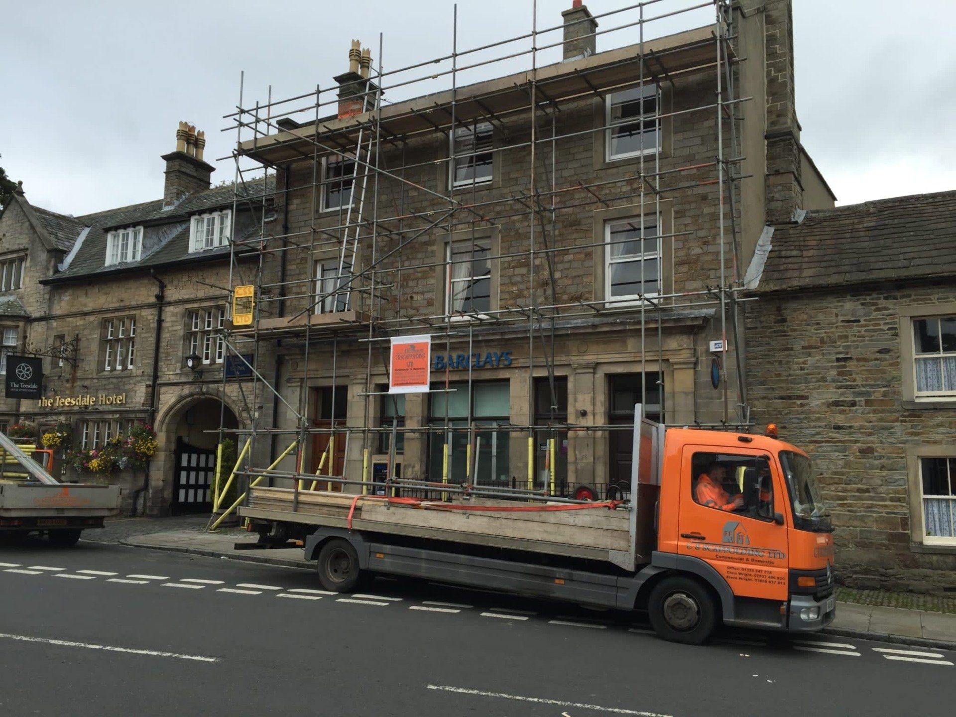 Orange scaffold lorry parked outside the house