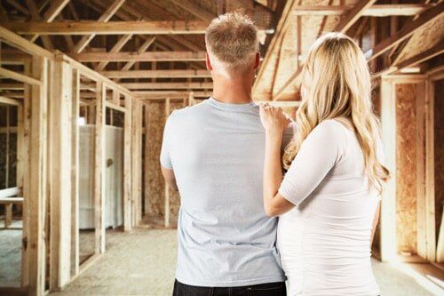 A Man and a Woman Are Standing in a House Under Construction — Lifestyle Finance Mackay in Mackay, QLD