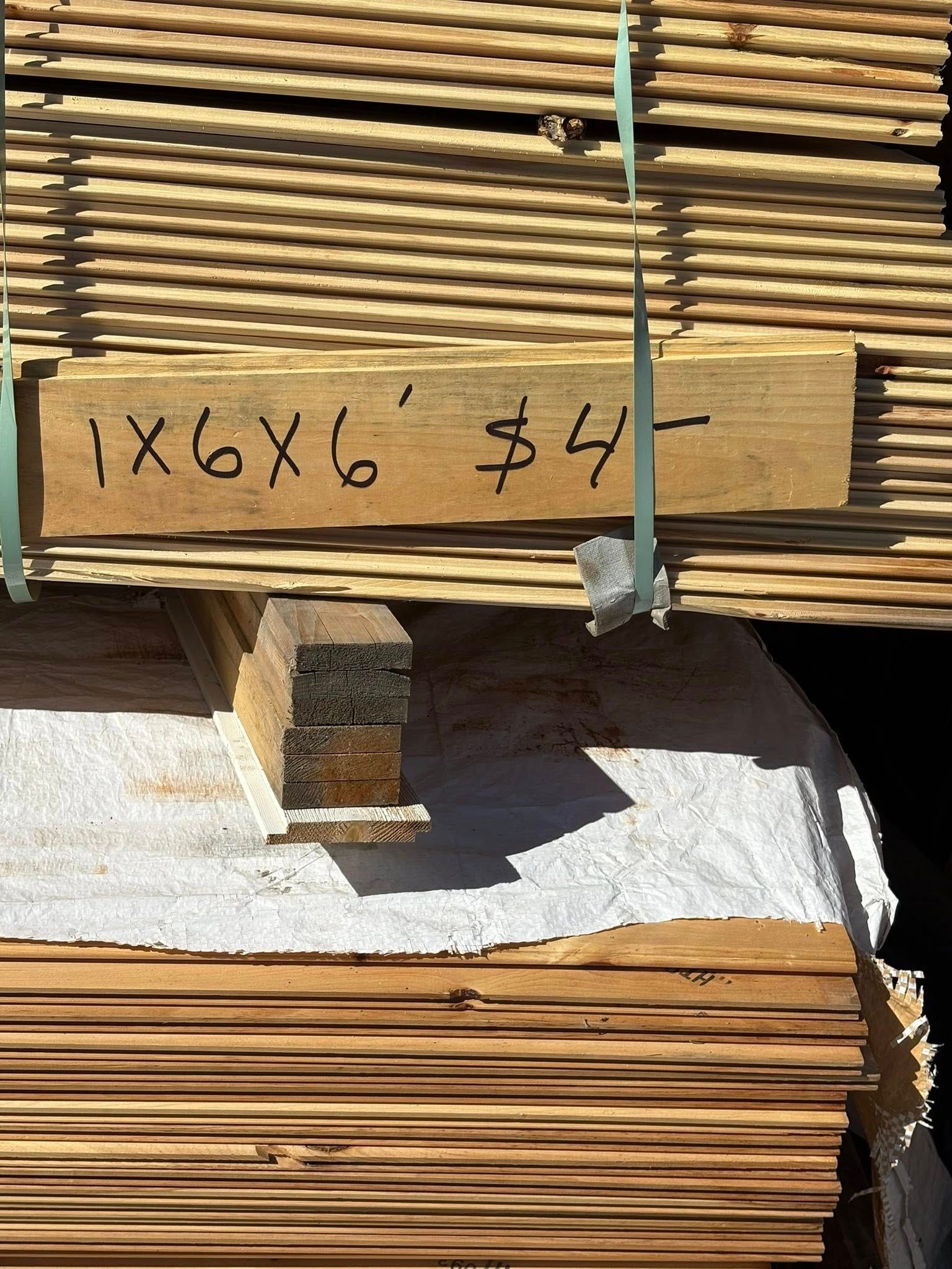 Bundle of wooden planks with a sign that reads 
