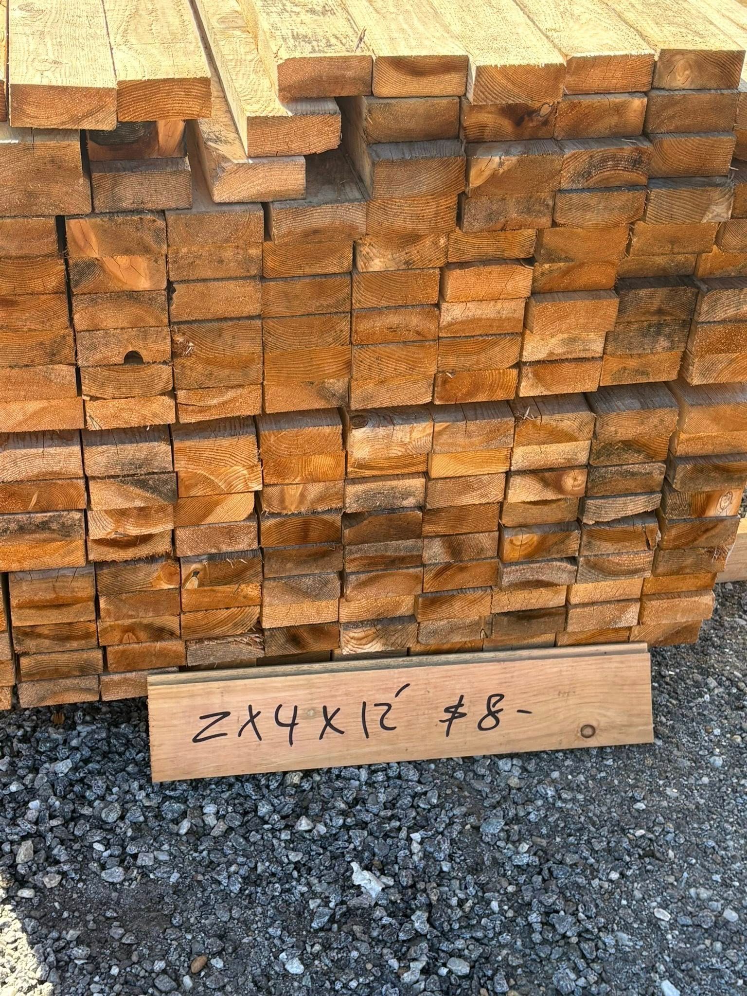 Pile of lumber with a sign.