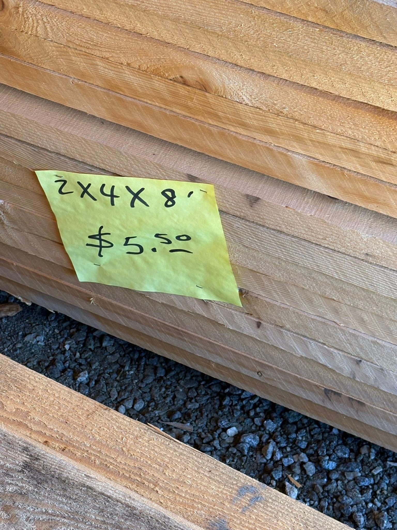 Pile of 2x4x8' lumber with price tag of $5.32.