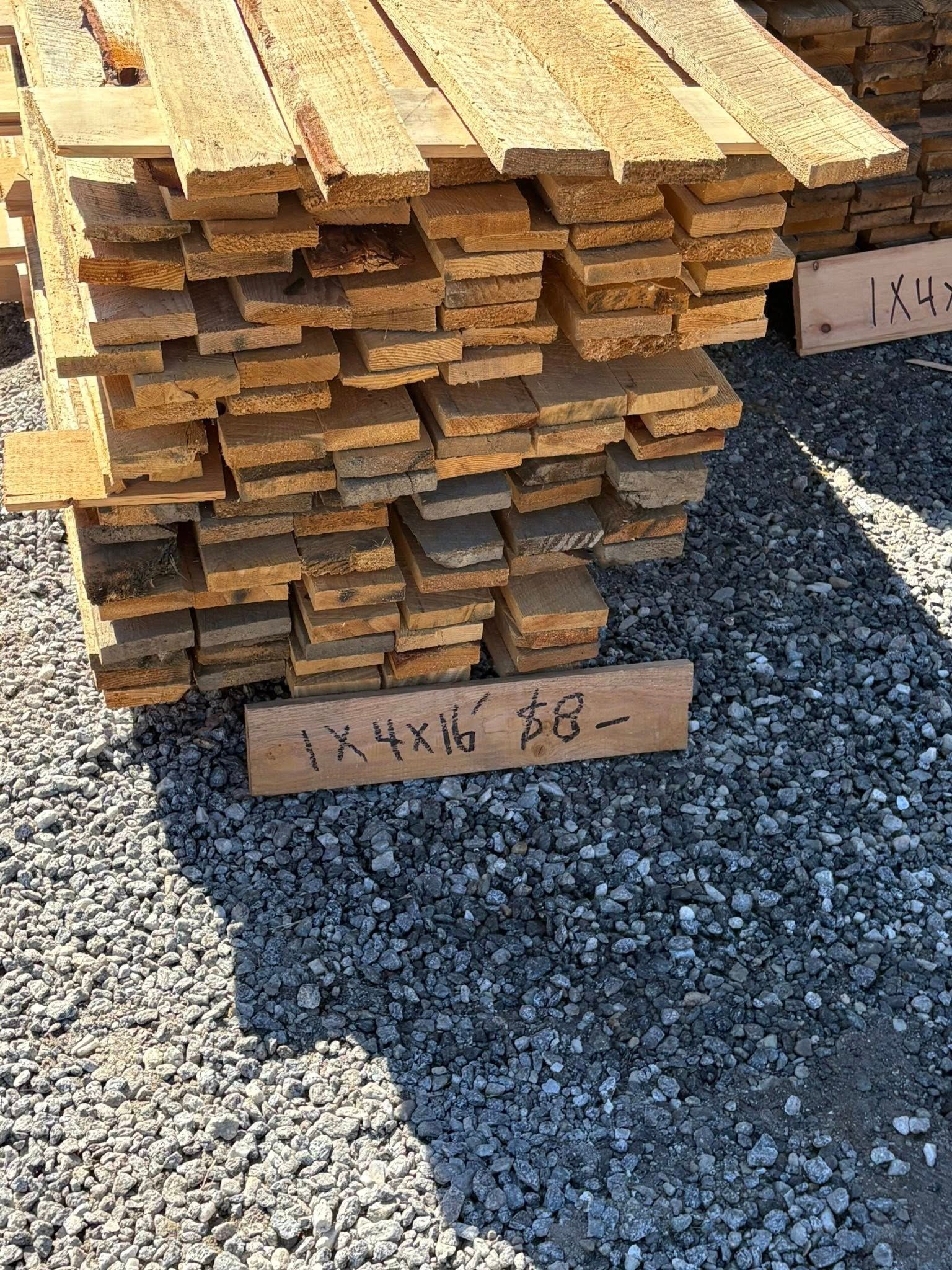 Stack of weathered wooden planks labeled.