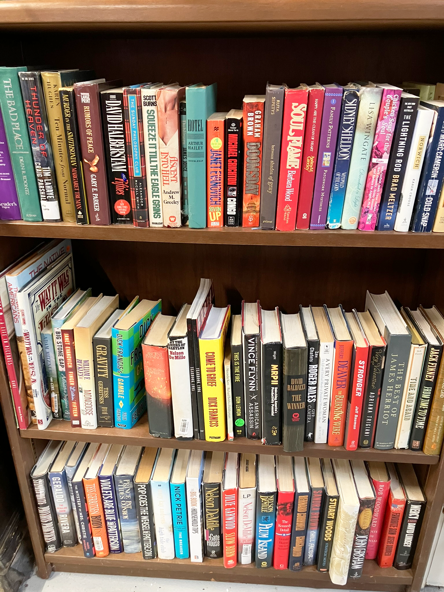 Bookshelves filled with various books of different colors and sizes.