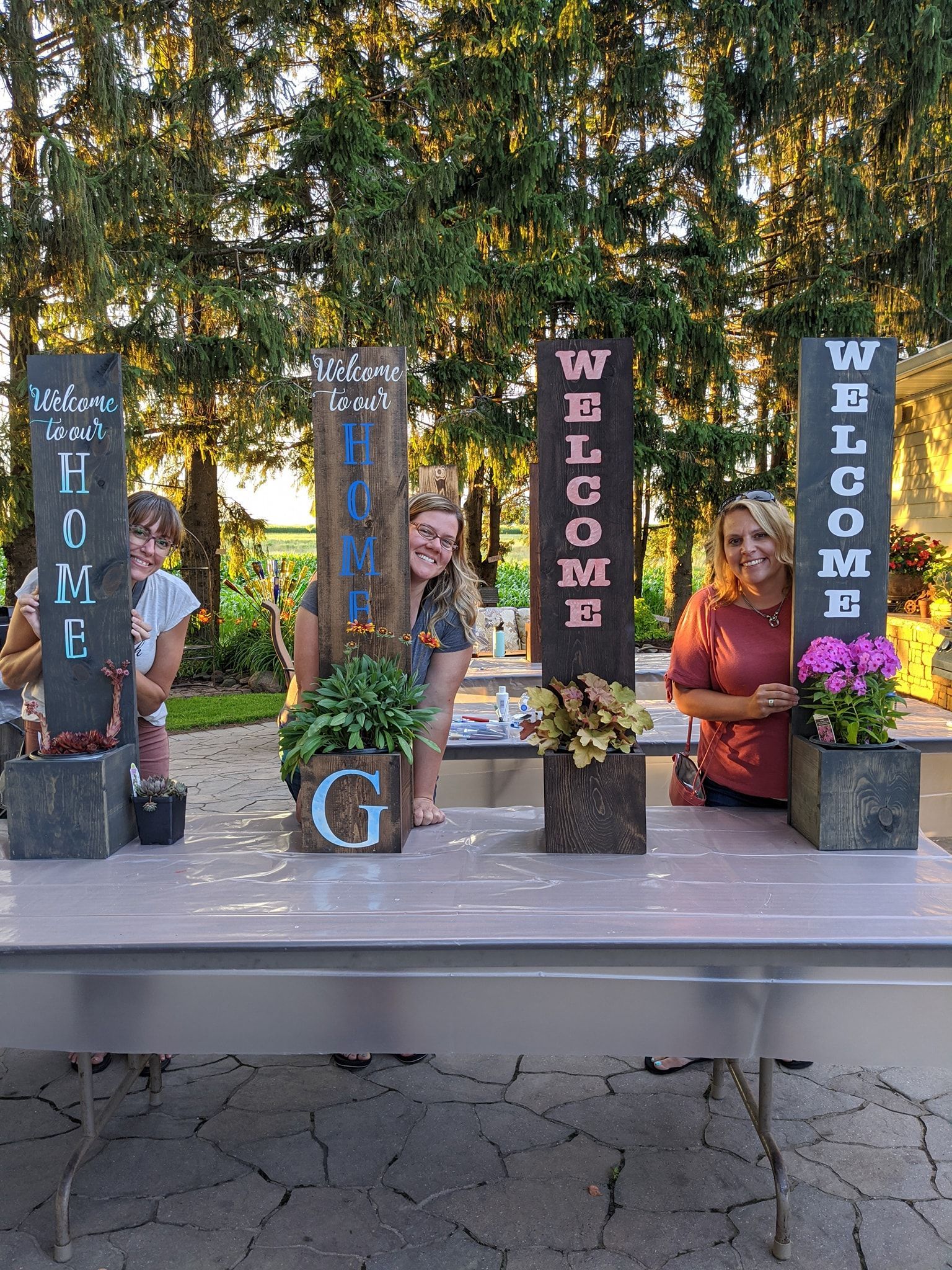 A group of people standing around a table with signs on it.