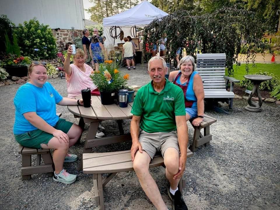 A group of people are sitting at a picnic table