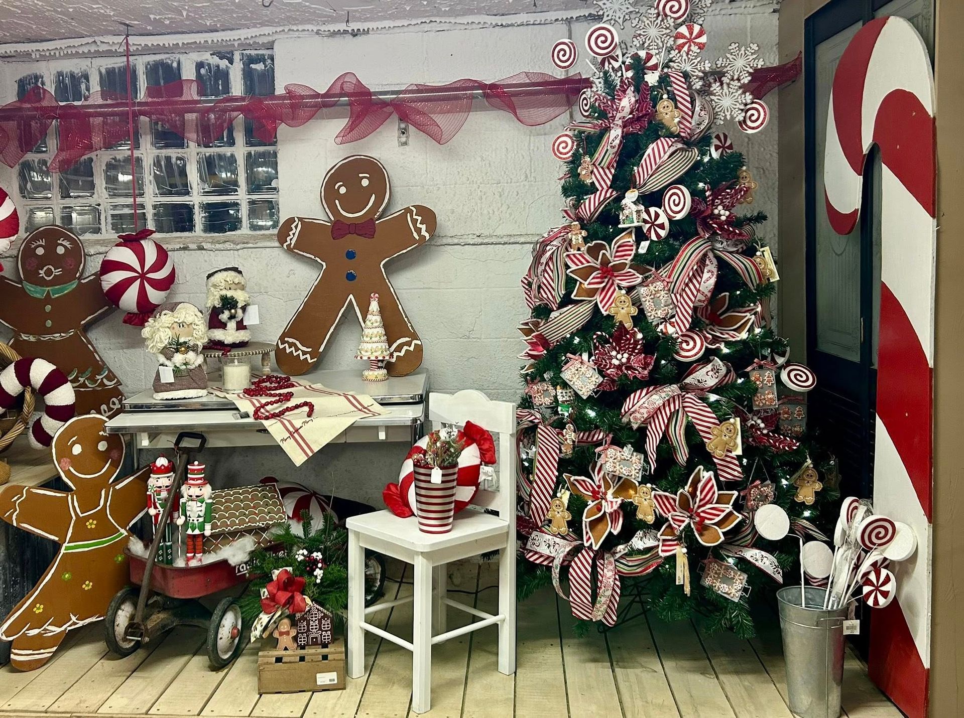 Christmas display with gingerbread men, candy canes, and decorated tree.