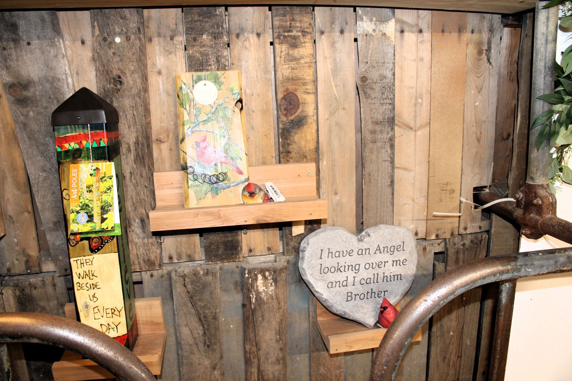 Wooden art display with three pieces: painted pillar, framed artwork, and heart-shaped stone with text.