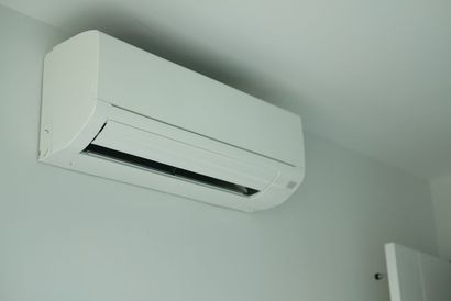 Air conditioner inside the room on white wall background