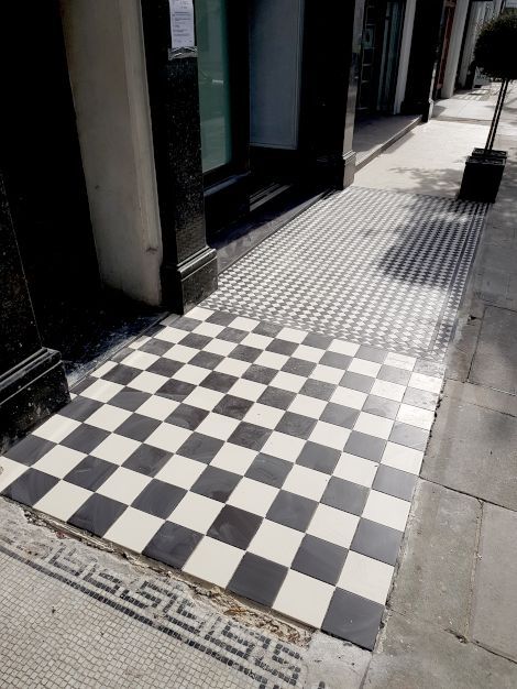 A high quality pristine checkered tiled floor outside chic boutique stores in Marylebone London, completed by Master tiling