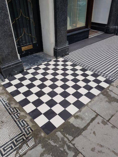 A high quality pristine checkered tiled floor outside chic boutique stores in Marylebone London, completed by Master tiling