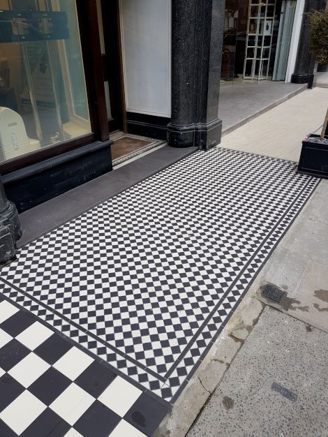 A high quality pristine checkered tiled floor outside chic boutique stores in Marylebone London, completed by Master tiling