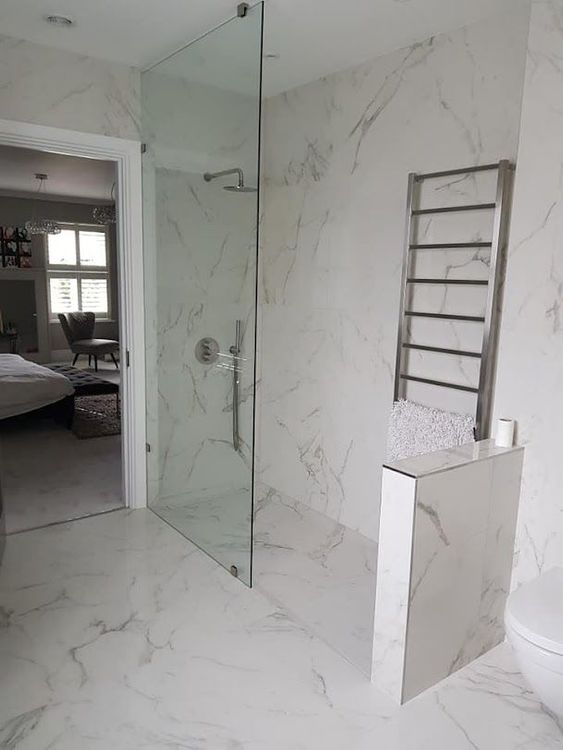 A pristine white marble tiled bathroom, completed in London by Master Tiling