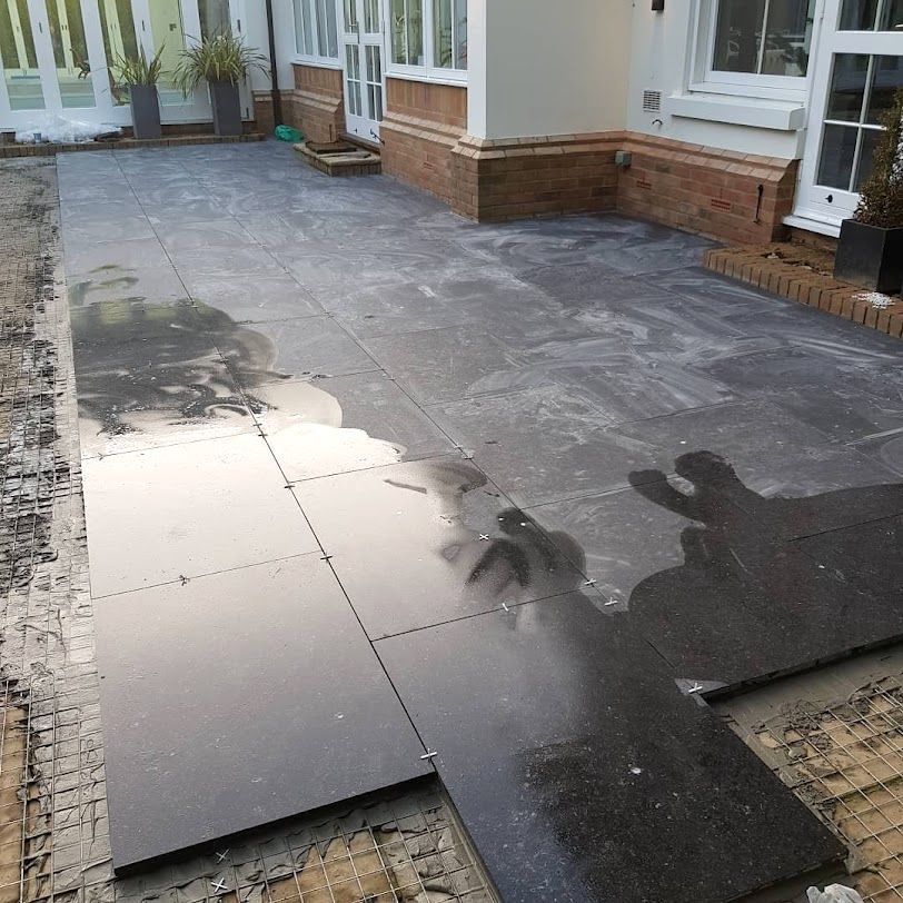 A large tiled Courtyard, outside a London building. The patio area was created by Master Tiling