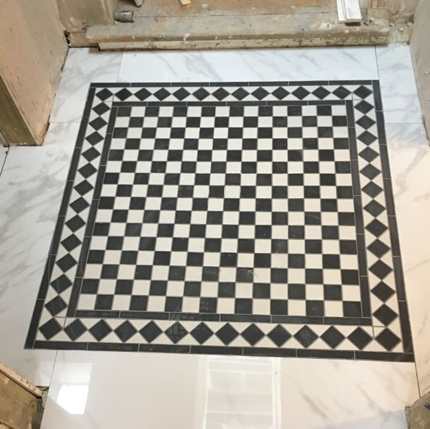 A lovely black and white checkered tile installation with geometric pattern. Completed in London by Master Tiling.