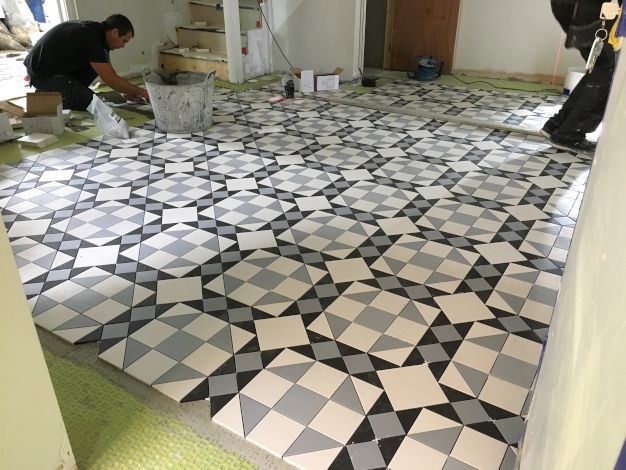 A lovely grey, blue and white checkered tile installation with geometric pattern. Completed in London by Master Tiling.